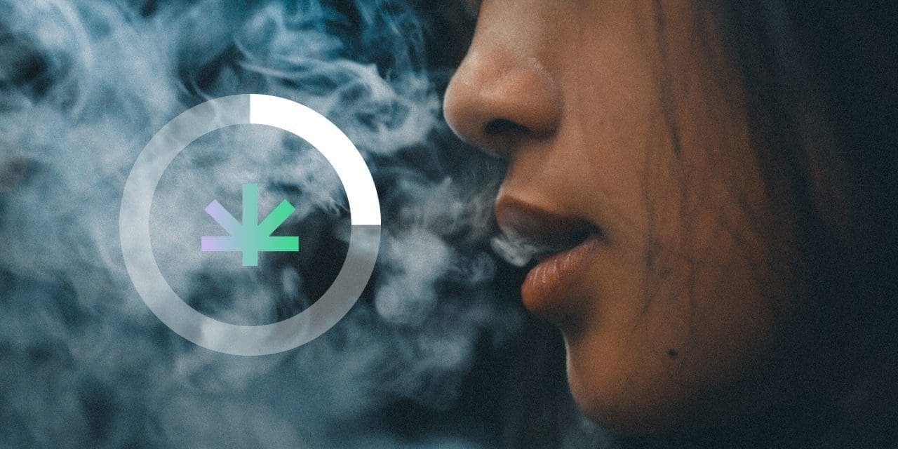 closeup of woman's mouth blowing smoke